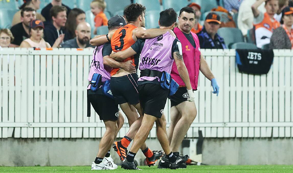 Stephen Coniglio was helped off the field following a nasty tackle. Picture: Getty