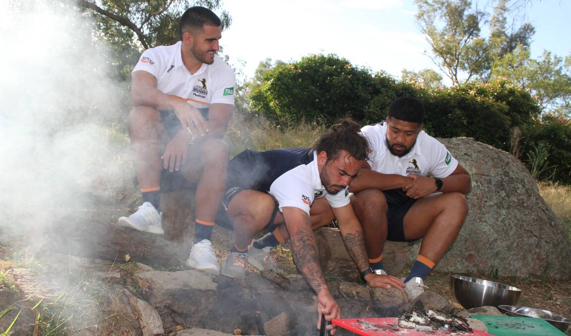 Tom Wright, Andy Muirhead and Folau Fainga'a tried Indigenous cooking techniques as part of First Nations round activities this week. Picture: Brumbies Media