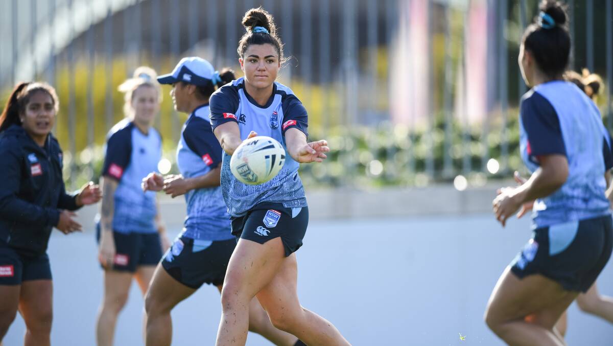 Millie Boyle passes to another rugby union convert in Tiana Penitani at Blues training. Picture: NRL Photos