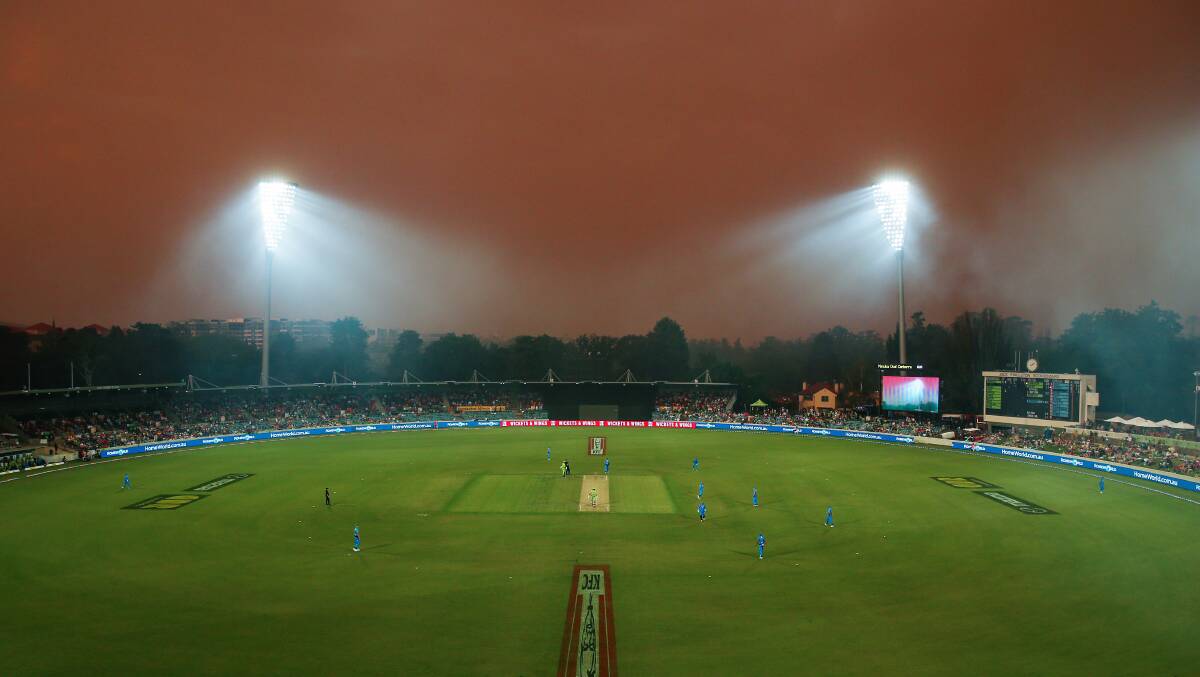 The smoke rolled in and covered Manuka Oval in a matter of moments on Saturday night to force the players and umpires off the park. Picture: Getty
