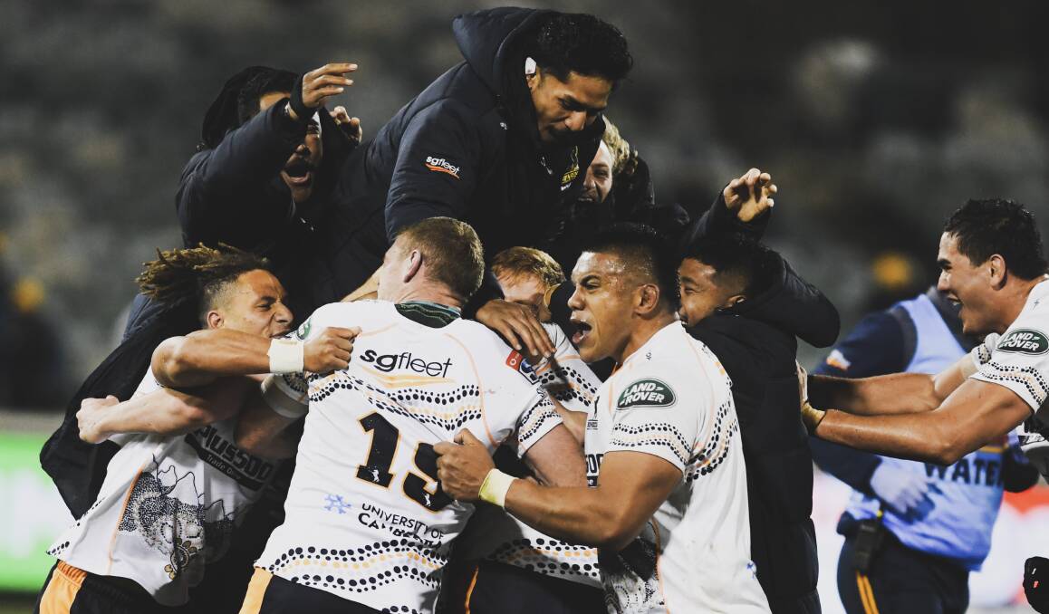 The Brumbies mob Mack Hansen after he nailed the winning penalty. Picture: Dion Georgopoulos