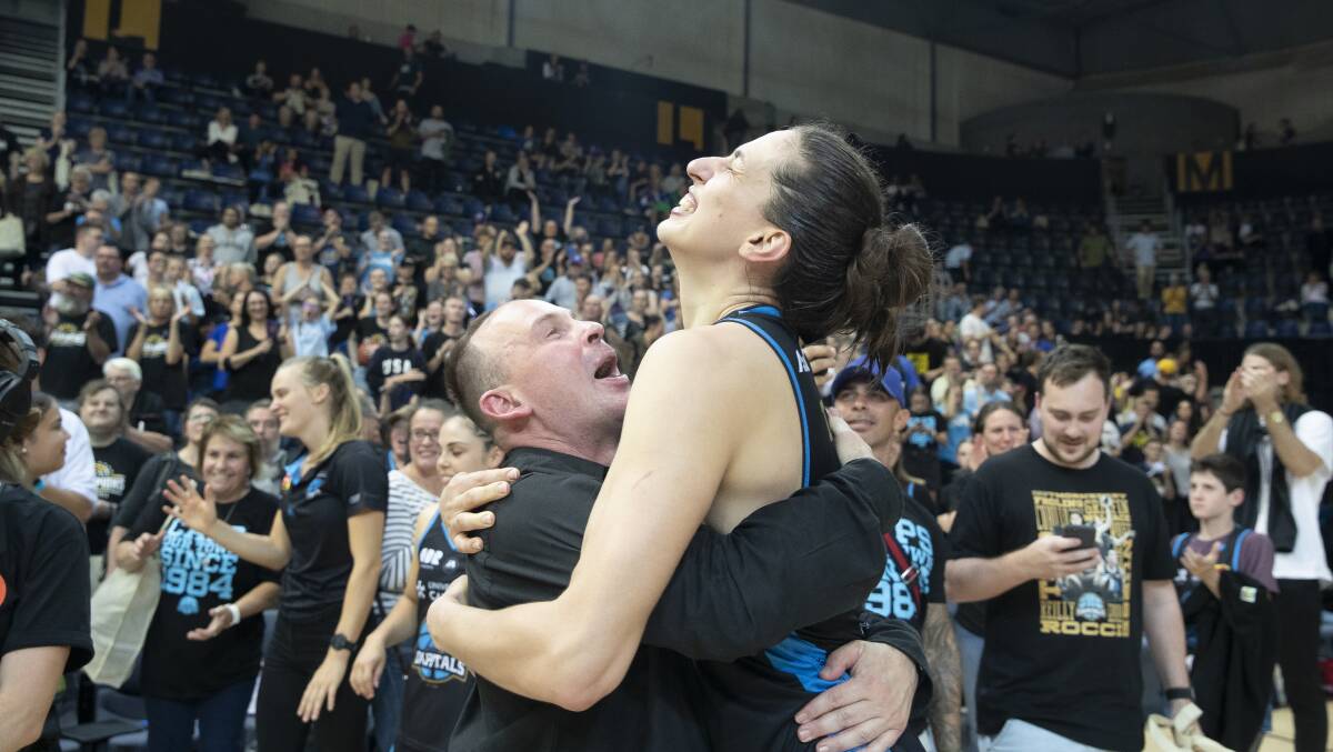 Paul Goriss and Marianna Tolo embrace after claiming the title. Picture: Sitthixay Ditthavong