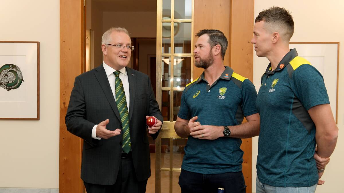 Scott Morrison with this year's Prime Minister's XI co-captains, Dan Christian and Peter Siddle. Picture: Getty