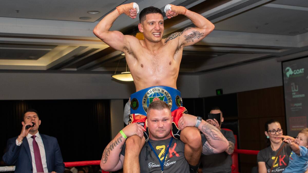 Jorge Kapeen was hoisted onto trainer Dennis Arthur's shoulders after winning the NSW welterweight title. Picture: Dimitri Yianoulakis