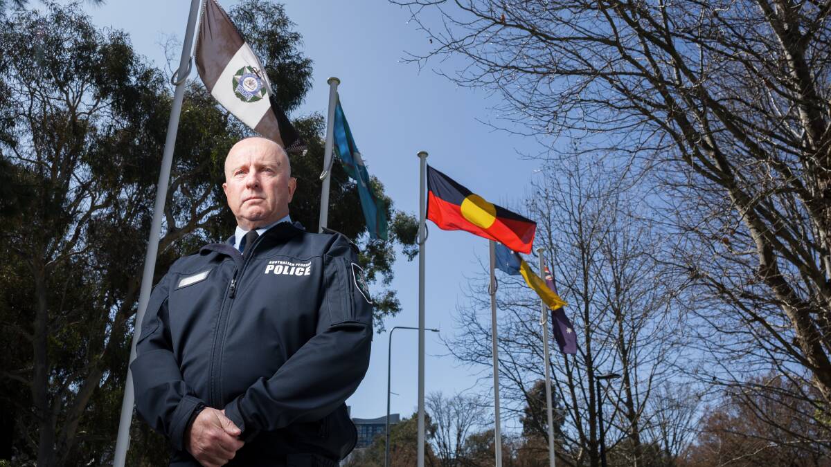 Deputy Commissioner Neil Gaughan in front of an Australian Federal Police flag. Picture by Sitthixay Ditthavong