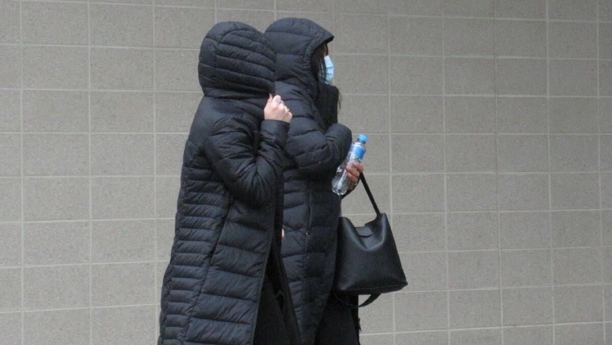 Samantha Chatfield, left, hides her face outside court in July. Picture: Toby Vue