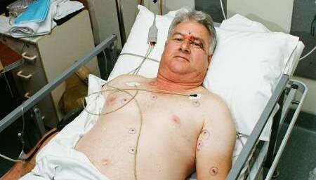 Security guard Kevin Matangi in his hospital bed after being shot in the armed robbery. Picture: Supplied