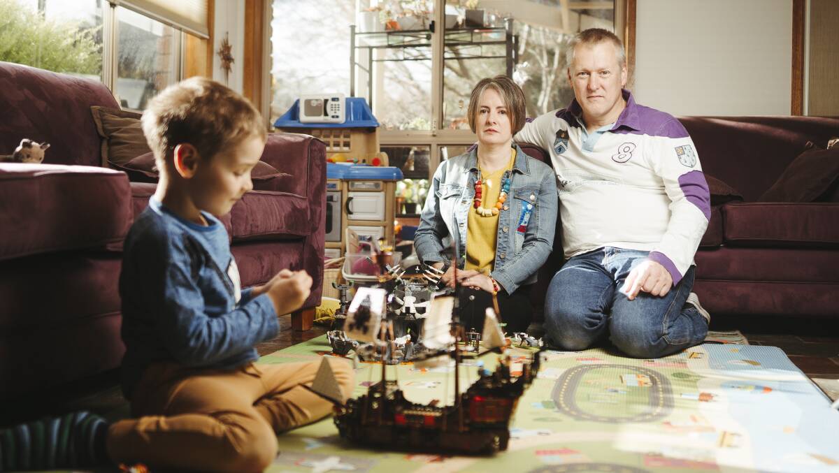 Blake's brother, Aidan Corney, plays with toys at home as parents Camille Jago and Andrew Corney look on. Picture: Dion Georgopoulos