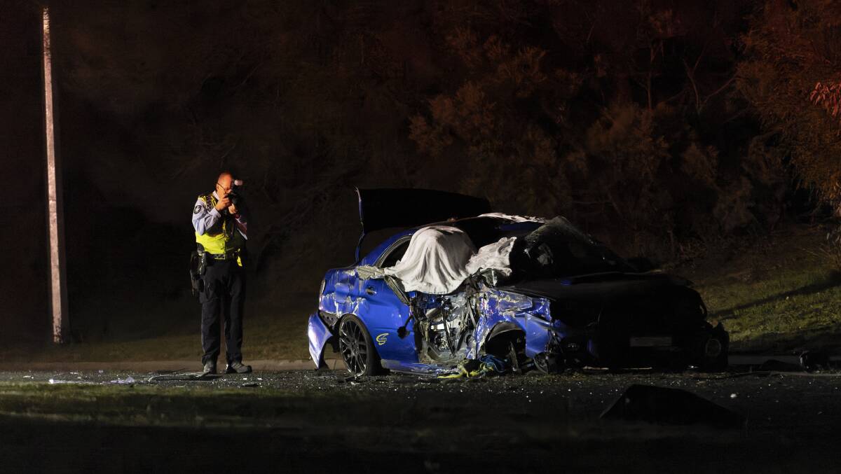 Police examine the crashed Subaru WRX at the scene on Kingsford Smith Drive. Picture: Keegan Carroll