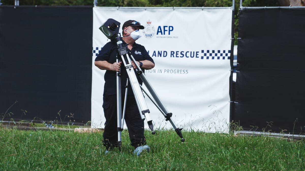 A police officer sets up equipment during a forensic search at the scene of the alleged Page murder. Picture: Dion Georgopoulos
