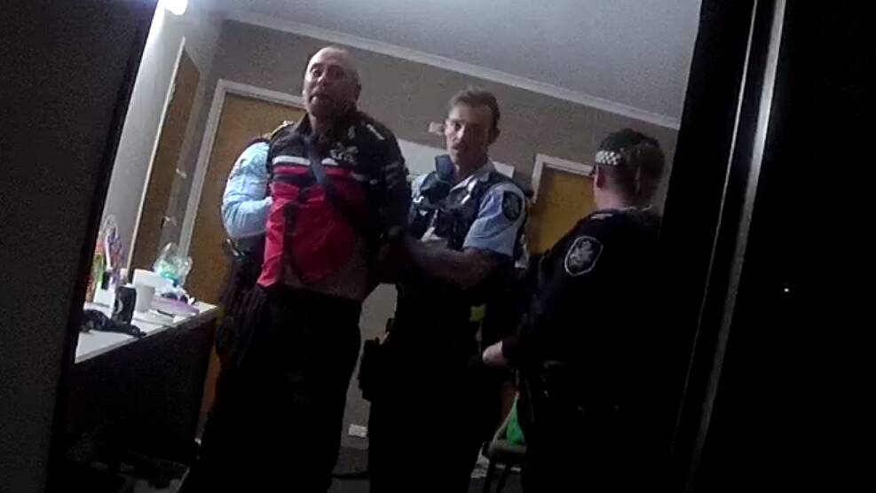 Luke Marsh is taken from his motel room in handcuffs after being Tasered and pepper-sprayed.