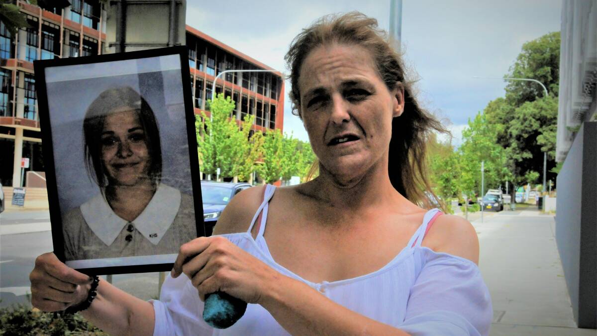 Charli Powell's mother, Sharon Moore, displays a photograph of her outside the Queanbeyan courts. Picture: Blake Foden