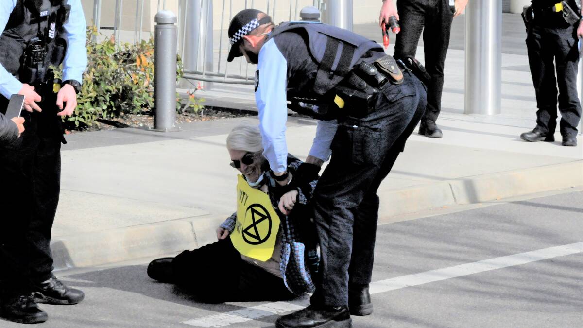 Sarah "Daisy" Edwards is arrested outside the ACT courts on Wednesday. Picture: Blake Foden