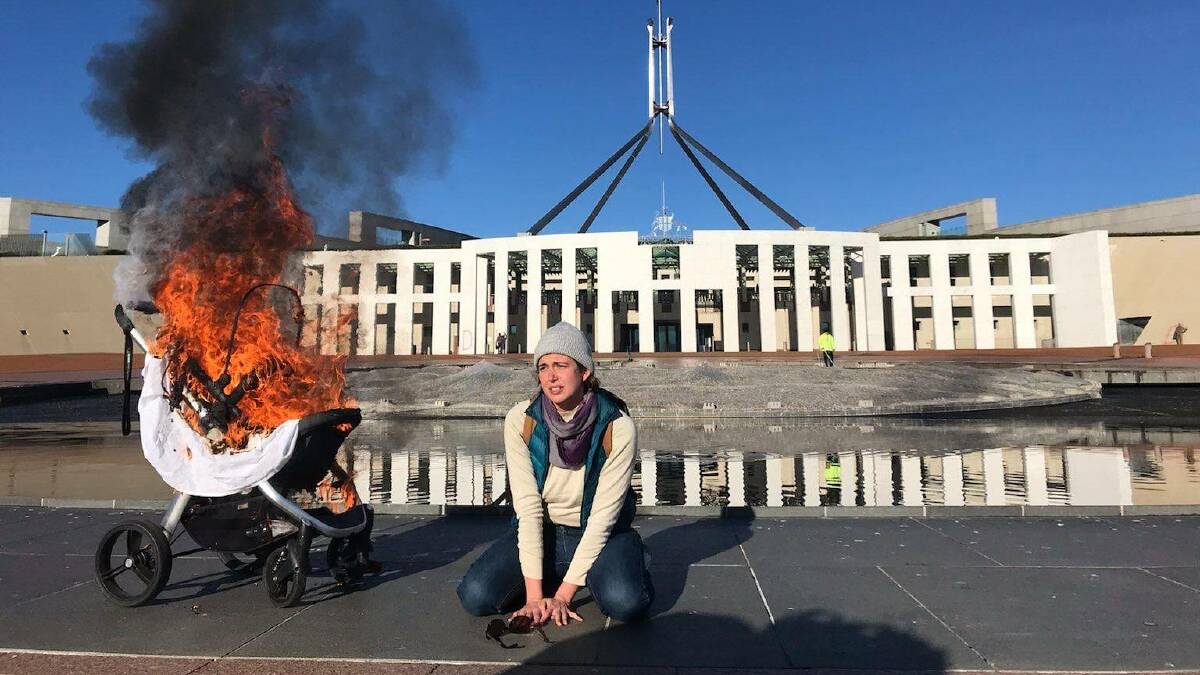 "Violet" Coco, glued to the Parliament House forecourt beside a burning pram in an incident she was sentenced over last September. Picture: Supplied