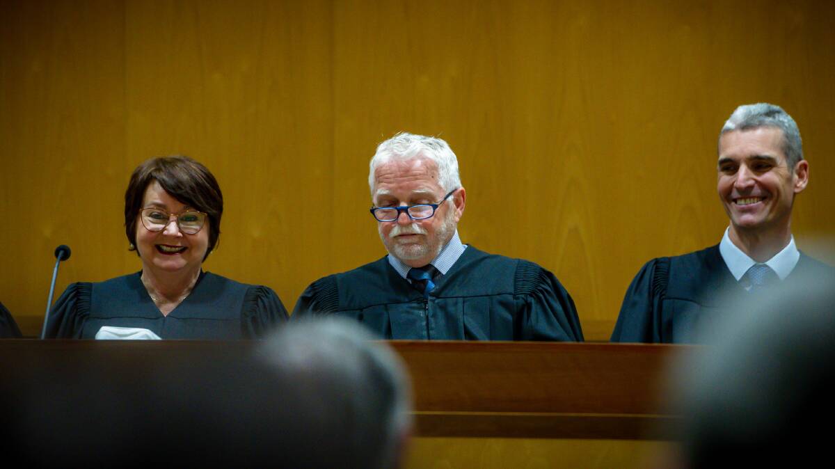 Magistrate Peter Morrison, centre, jokes at his retirement ceremony to the amusement of Chief Magistrate Lorraine Walker, left, and magistrate Glenn Theakston, right. Picture: Elesa Kurtz