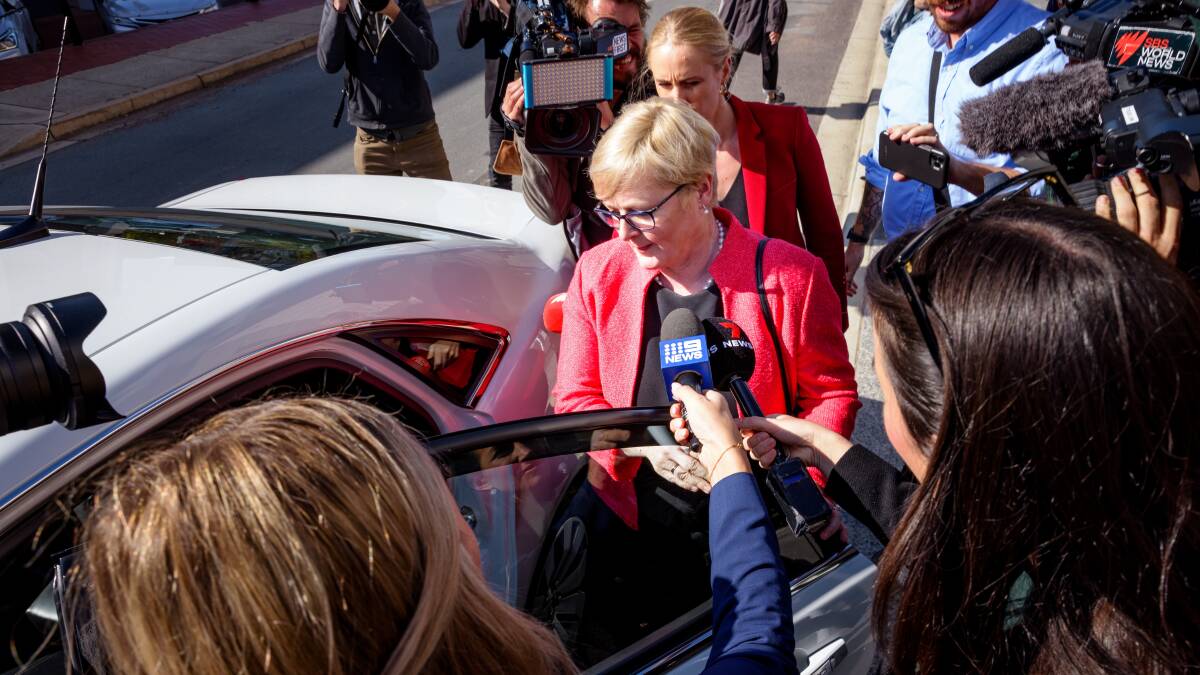 Senator Linda Reynolds is surrounded by journalists outside court after giving evidence in the trial of Bruce Lehrmann. Picture by Sitthixay Ditthavong