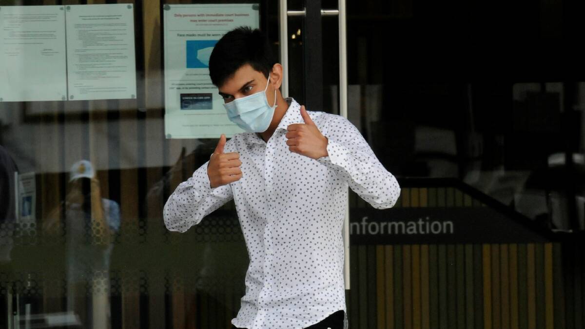 Anam Haque celebrates his freedom with a thumbs-up for reporters outside court on Tuesday afternoon. Picture: Blake Foden