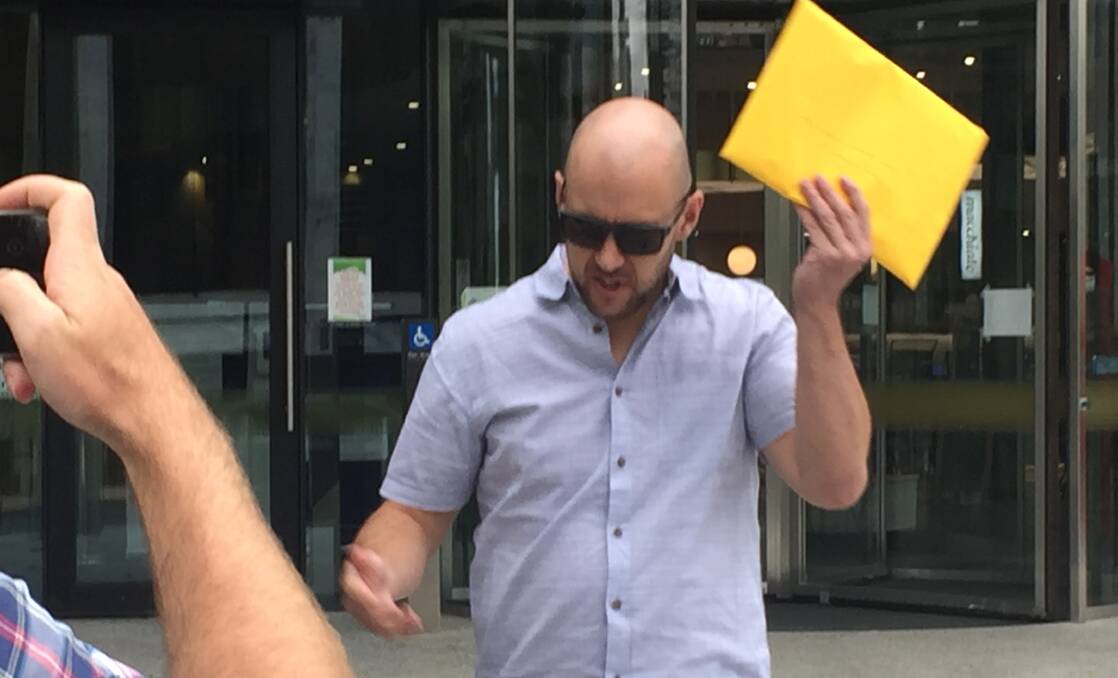 James Raftery with the yellow envelope he used to strike a reporter in the face. Picture: Blake Foden