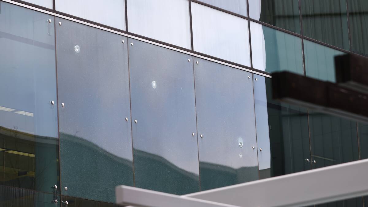 Bullet holes in the windows at Canberra Airport after the incident. Picture: Keegan Carroll