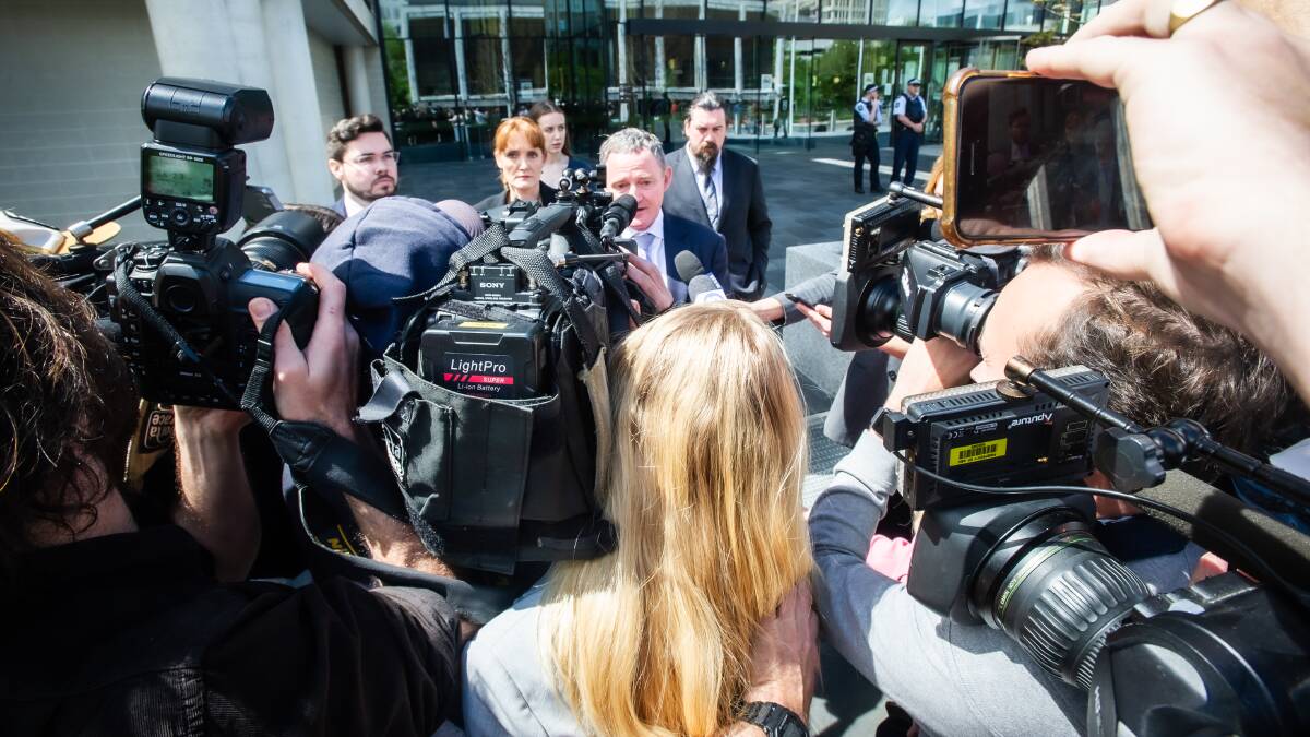 Bruce Lehrmann, left, looks on as defence barrister Steven Whybrow speaks to hordes of media outside court on Thursday. Piciture by Karleen Minney