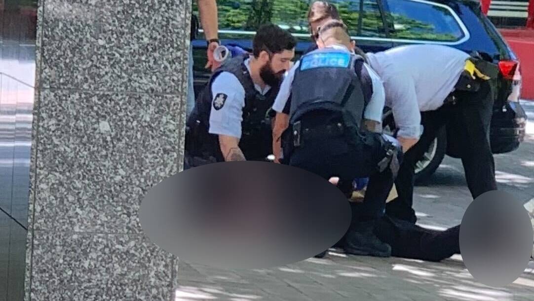 Police arrest the alleged killer in Ainslie Place on Saturday. Picture: Jason Moffett