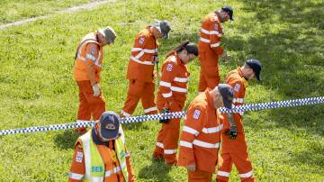 State Emergency Service volunteers search an area near the Weston Creek skatepark after the fatal fight. Picture: Sitthixay Ditthavong