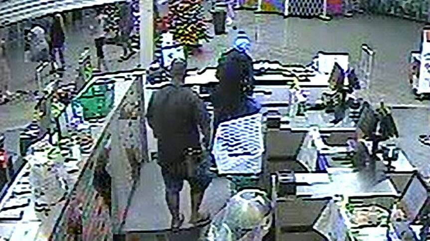 A shopper approaches Joshua Sullivan from behind and prepares to place the 27-year-old in a "bear hug" to restrain him at Woolworths in Calwell. Picture: Supplied, CCTV