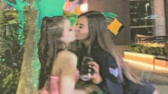 Ashley Carter-Gair, right, kisses a friend on the lips while infected with COVID-19. Picture: Supplied