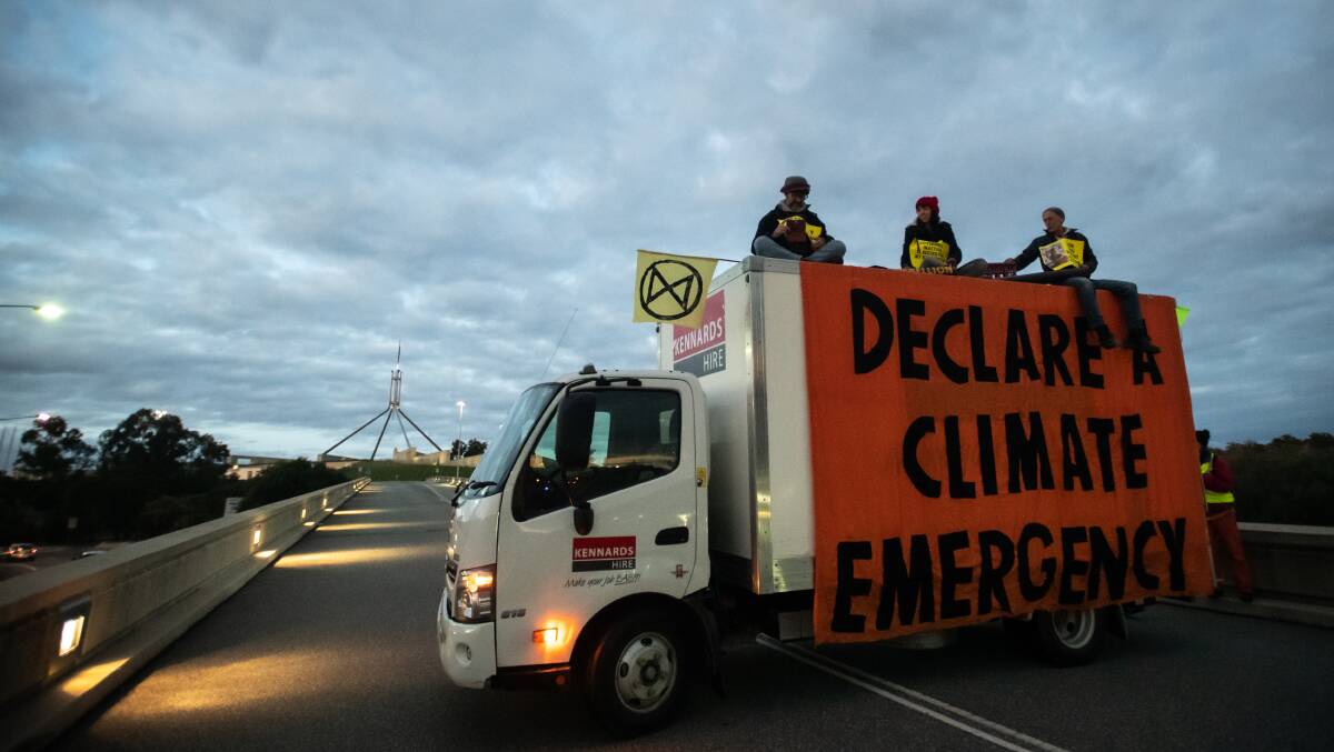 Extinction Rebellion protesters on top of a truck that blocked traffic near Parliament House last May. Picture: Karleen Minney