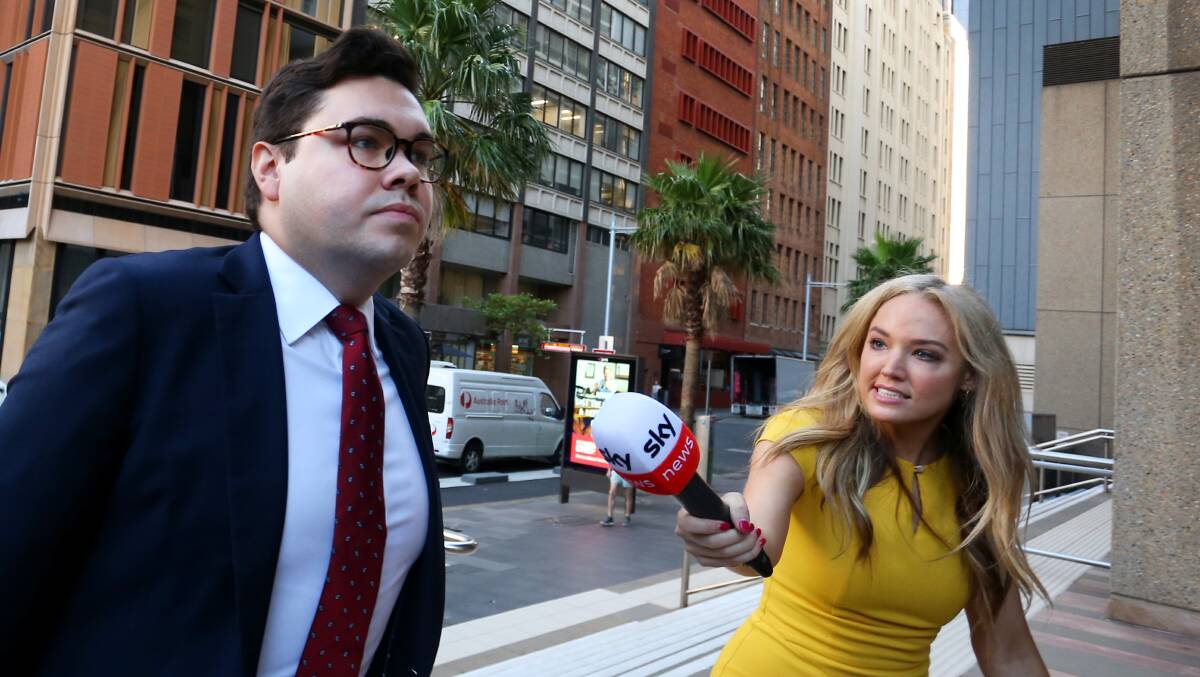 Bruce Lehrmann, left, is approached by a journalist outside the Federal Court. Picture Getty Images