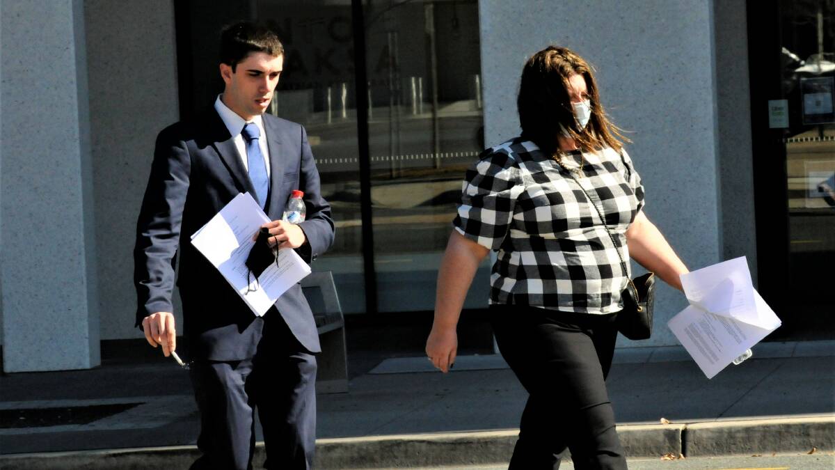 Darcy Page, left, walks through Civic on Monday. Picture: Blake Foden
