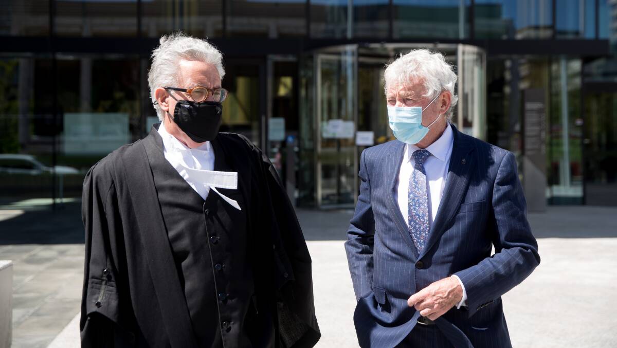 Bernard Collaery, right, speaks with barrister Ken Archer outside court. Picture: Sitthixay Ditthavong