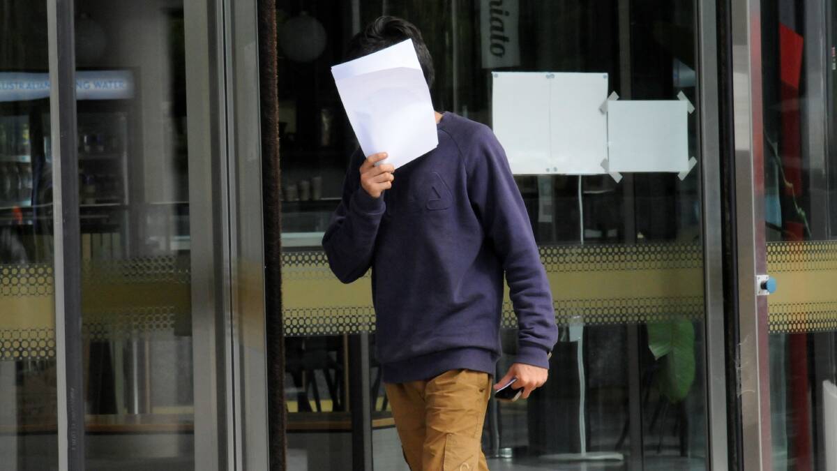 Rahul hides behind court paperwork on Wednesday afternoon. Picture: Blake Foden