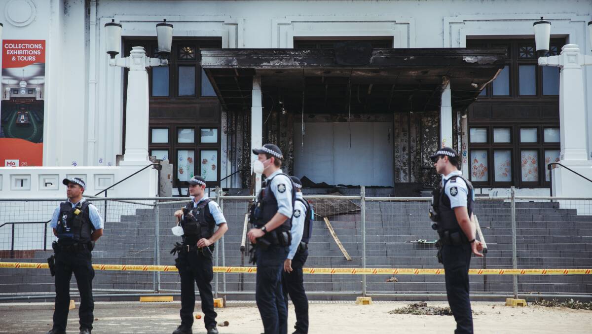 Police officers stand outside the damaged entrance to Old Parliament House following the December 30 fire. Picture: Dion Georgopoulos