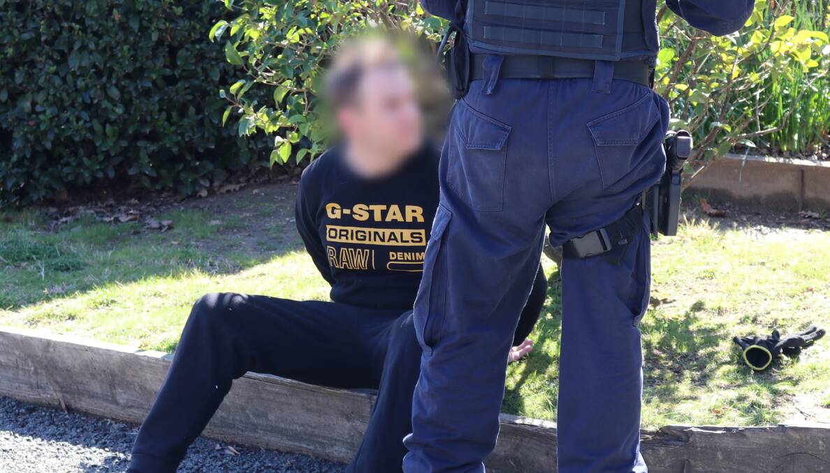One of the accused is arrested in Queanbeyan on Thursday. Picture: NSW Police