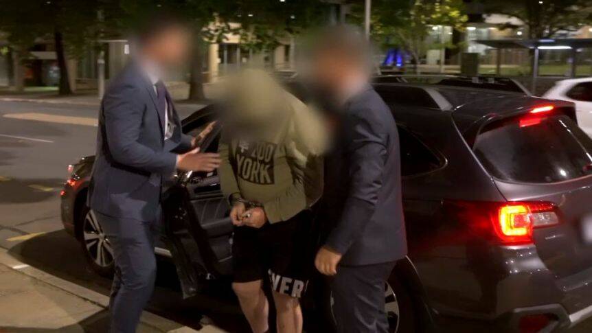 Ashleigh Wayne Wilson is escorted into the City Police Station after being extradited to Canberra from Tasmania. Picture: ACT Policing