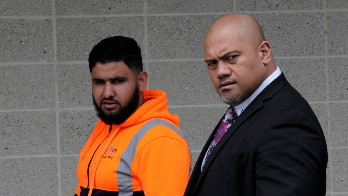 Ali Alaraja, left, leaves court with lawyer Toni Tu'ulakitau on Wednesday. Picture by Blake Foden