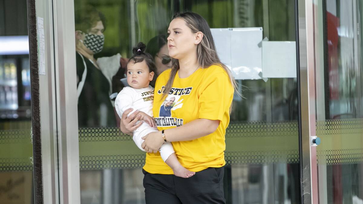 Monique Eramo and her daughter, wearing clothes emblazoned with a picture of Pitasoni Ulavalu and the word "justice", outside court. Picture: Keegan Carroll