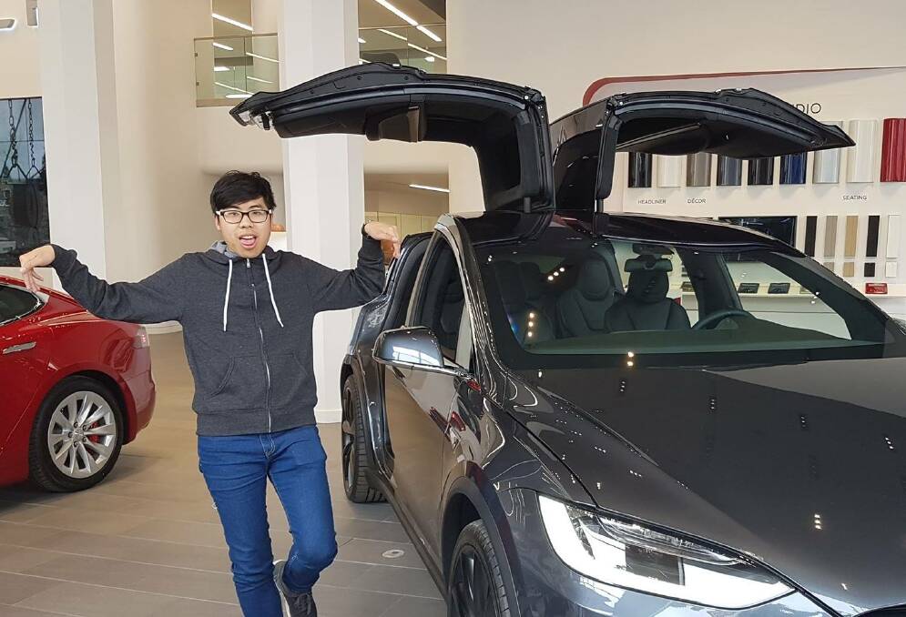 Stefan Qin poses with an expensive car. Picture: Facebook