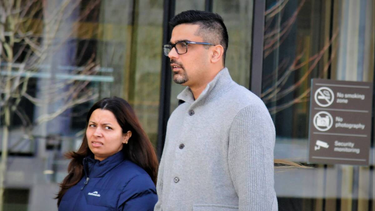 Karan Talwar, right, leaves court with a supporter on Friday. Picture: Blake Foden