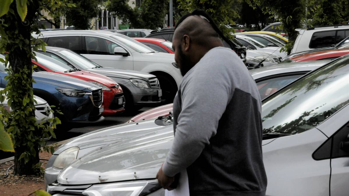 Osaiasi Kupu weaves through parked cars to avoid being photographed on Wednesday. Picture: Blake Foden