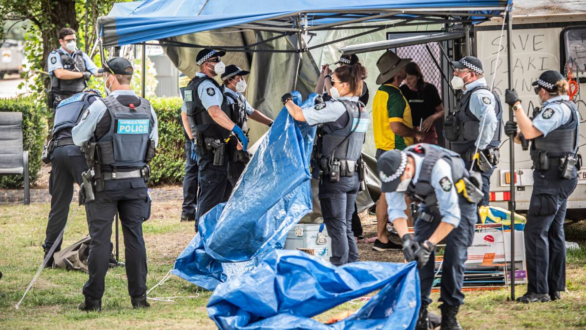 Police officers pack up camping equipment in Parkes on Friday. Picture: Karleen Minney