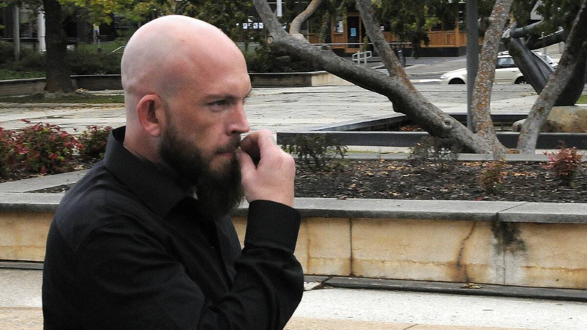 Christopher Cunningham smokes the very last remnants of a cigarette outside court in 2020. Picture: Blake Foden