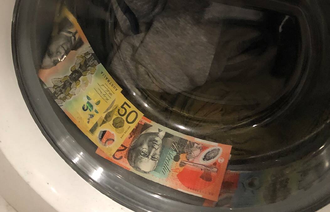 Cash in the washing machine at John Wright's unit. Picture: ACT Policing