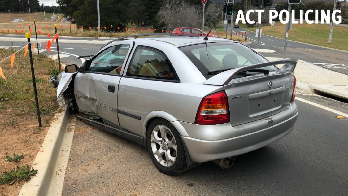 The silver Holden Astra, which collided with a street sign and crashed into a gutter during an alleged police pursuit. Picture: ACT Policing
