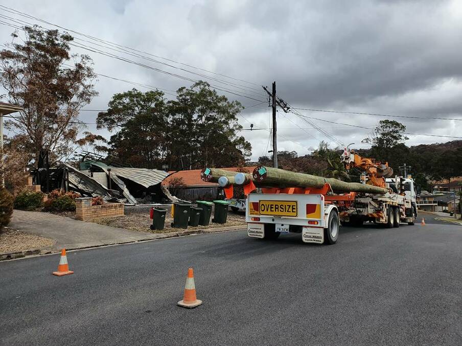 Crews working to install new power poles at Surf Beach. Image: Supplied.