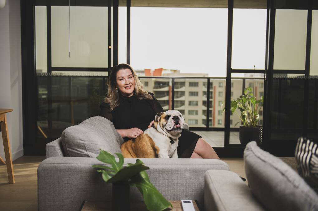 Cassandra Smith, with Archibald, at her new penthouse apartment at Braddon's Midnight development. Picture: Dion Georgopoulos