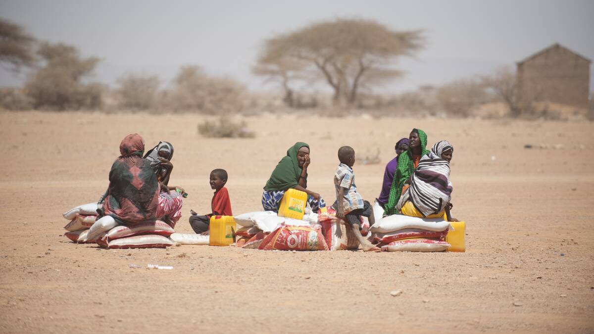 A small group of families in the Sool region of Somalia wait for transport to take the food distributed by the ICRC. Picture: Pedram Yazdi/ICRC