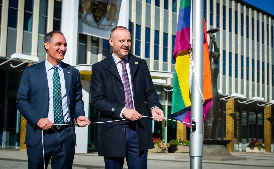 Chief Minister Andrew Barr (right) raising the rainbow flag out the front of the Legislative Assembly for International Day Against Homophobia, Transphobia and Biphobia with Charge d'Affaires of the US embassy Michael Goldman. Picture: Karleen Minney
