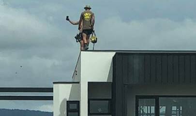 An image taken by WorkSafe inspectors showing a person working at heights with no fall protection. Picture: Supplied